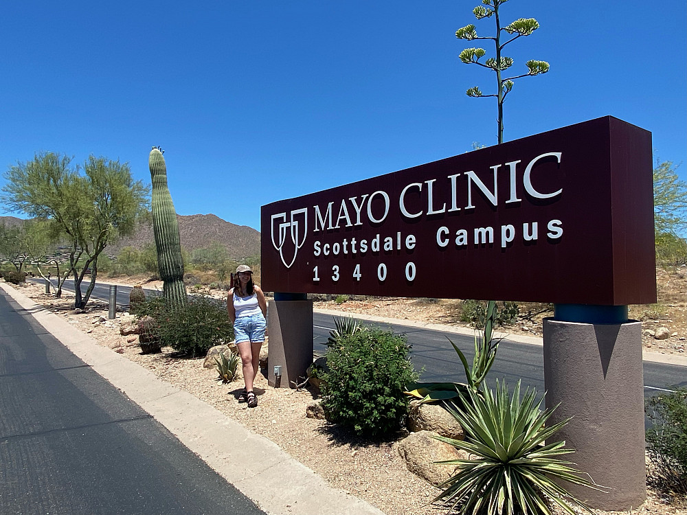 Lisenko stands in front of Mayo Clinic sign in Scottsdale, Arizona. 