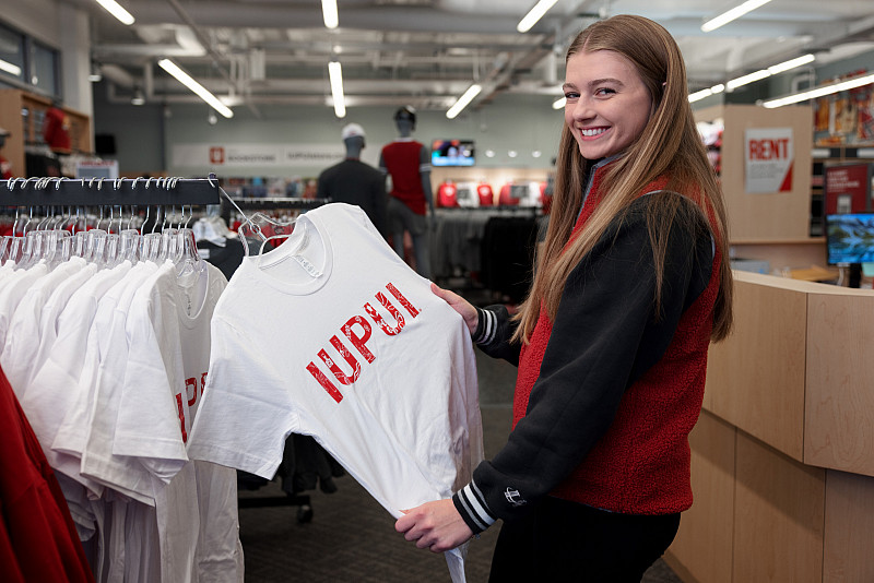 20221205 Cadee Thompson LK 013 IUPUI student Cadee Thompson poses for a portrait along with the winning t-shirt she designed. The photo was taken at the Campus Center o...