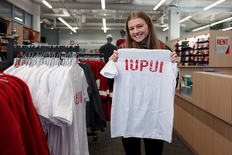 20221205 Cadee Thompson LK 017 IUPUI student Cadee Thompson poses for a portrait along with the winning t-shirt she designed. The photo was taken at the Campus Center o...